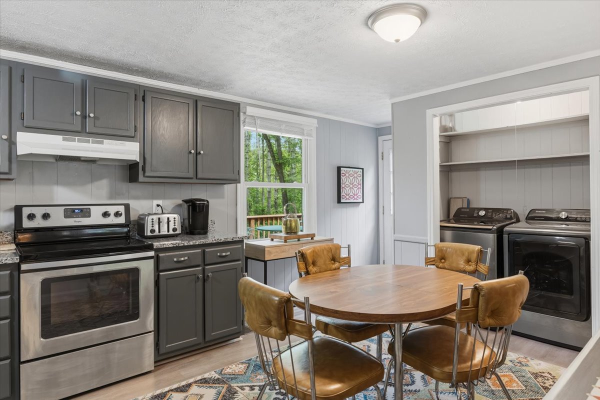 Kitchen with stove and dining table